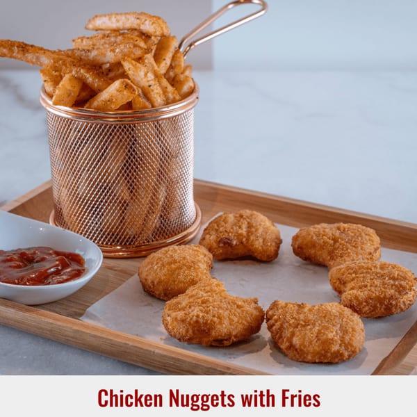 Golden chicken nuggets and seasoned fries in a metal basket, with a side of ketchup.